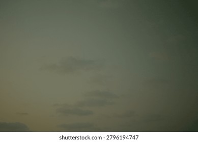 Analog camera capture of atmospheric clouds during twilight, showcasing a soft, diffused light and subtle color tones