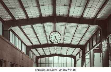 Analog clock hanging on the ceiling at the train station