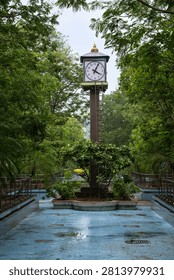 Analog Clock Tower Surrounded by Green Trees at Anna Nagar Park in Chennai, India