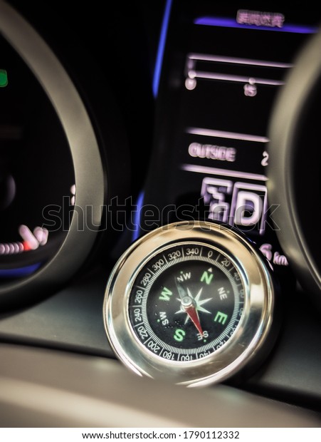 Analog compass\
in front of a digital\
speedometer