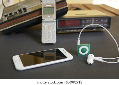 Analog To Digital: Old Radios, Cell Phone, IPhone And IPod With Earphones