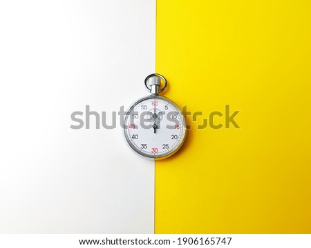 Analog Stop watch isolated and symmetry over white and yellow background