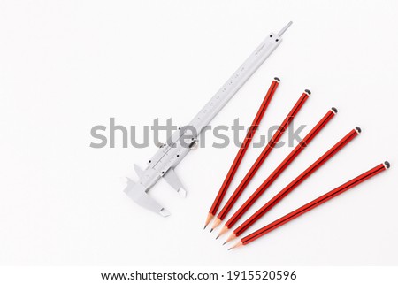Analog Vernier Caliper with Group of Five Pencils Isolated on White Background
