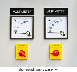 Analog voltmeter and amp meter with dial and arrow. Indoor electrical control panel. Indoor electrical current control panel.