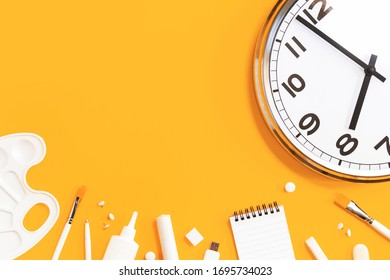 analogue plain wall clock on trendy saffron yellow orange background with white stationery items. Eight o'clock. Close up with copy space, time management or school concept and opening hours time