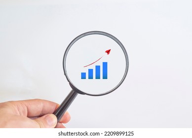 Analysis chart showing growth in a magnifying glass.
inflation analysis idea concept. - Powered by Shutterstock