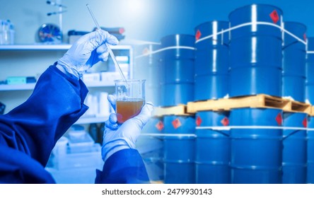 Analysis of chemical composition of oil. Laboratory assistant near barrels of fuel. Checking petroleum products for chemical composition. Lab technician holding oil sample in test tube - Powered by Shutterstock