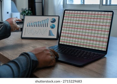 analysis data man using a tablet to analysis chart marketing company financial budget report strategy in office statistic professional Analyzing Financial Data On Computer