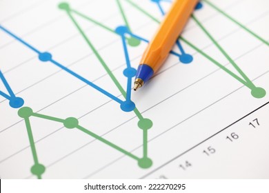 Analysis of financial statements (Line Graph). Business graph and ballpoint pen. Close-up.