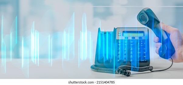 analysis of recorded telephone conversation. graphic interpretation of recording of telephone business conversations. black office voip phone with handset up on table on blurred office background - Shutterstock ID 2151404785
