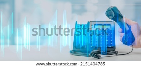 analysis of recorded telephone conversation. graphic interpretation of recording of telephone business conversations. black office voip phone with handset up on table on blurred office background