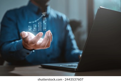 analysis, strategy, intelligence, software, cyberspace, tech, diagram, innovation, interface, virtual. A man is holding a laptop with a graph on the screen. The graph is showing a positive trend.