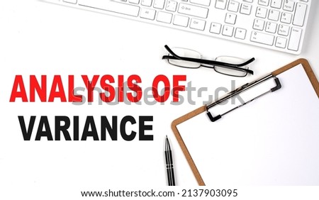 ANALYSIS OF VARIANCE text written on a white background with keyboard, paper sheet and pen