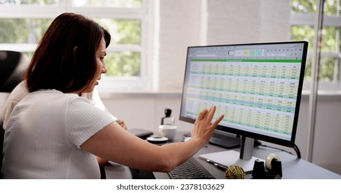 Analyst Employee Working On Spreadsheet Using Desktop Computer
