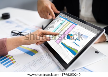 Analyst Employee Working On Spreadsheet Using Laptop