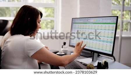 Analyst Employee Working On Spreadsheet Using Desktop Computer
