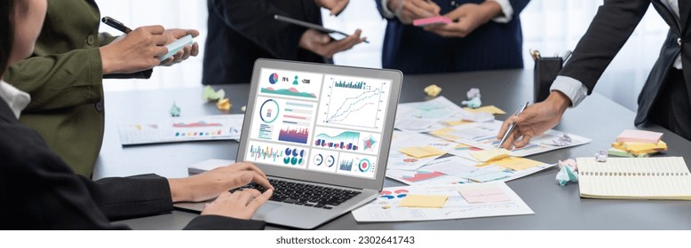Analyst team use sticky note for creative and analytic brainstorm for business idea with BI data dashboard on laptop screen. Analysis financial data visualization tech for marketing strategy. Prodigy