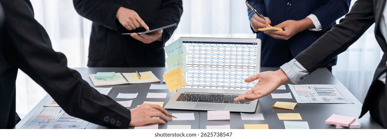 Analyst team use sticky note for creative and analytic brainstorm for business idea with BI data dashboard on laptop screen. Analysis financial data visualization tech for marketing strategy. Prodigy