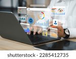 An analyst uses a computer and dashboard for data business analysis and Data Management System with KPI and metrics connected to the database for technology finance, operations, sales, marketing 