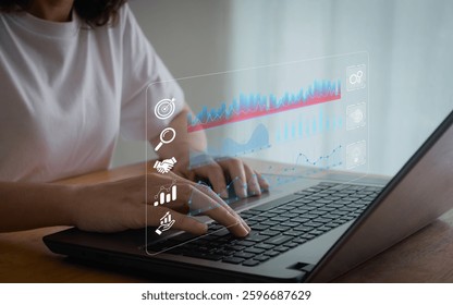 An analyst uses a computer and dashboard for data business analysis. Data Management System with KPI and metrics connected to the database for technology finance, operations, sales, digital marketing.