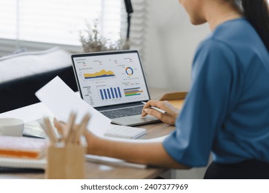 Analyst woman working with information database to analyze marketing and sales data. Business analytics dashboard with charts, metrics, and KPIs concept. - Powered by Shutterstock