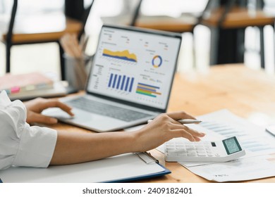 Analyst woman working with information database to analyze marketing and sales data. Business analytics dashboard with charts, metrics, and KPIs concept. - Powered by Shutterstock