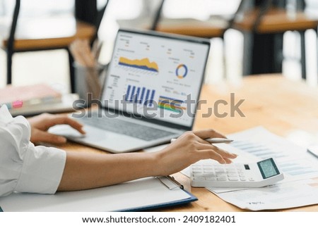 Analyst woman working with information database to analyze marketing and sales data. Business analytics dashboard with charts, metrics, and KPIs concept.