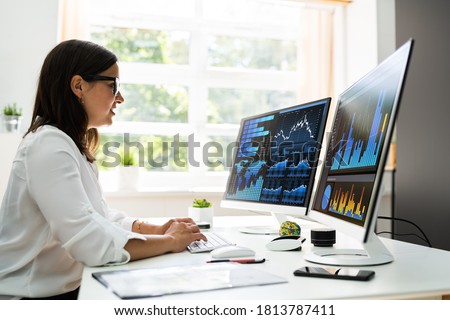 Analyst Women Looking At KPI Data On Computer Screen