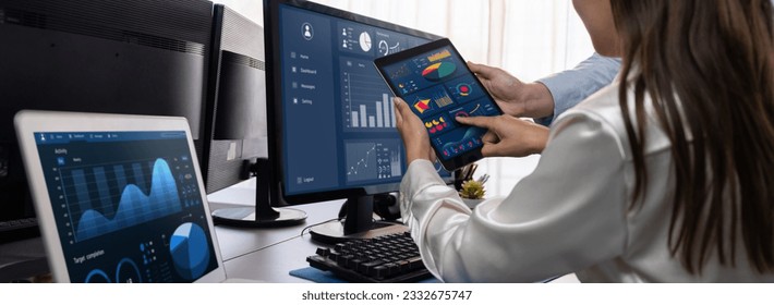 Analyst working on data analysis or BI dashboard on computer monitor. Business team analyzing financial data by Fintech in corporate office for business marketing and strategy planning. Trailblazing - Powered by Shutterstock