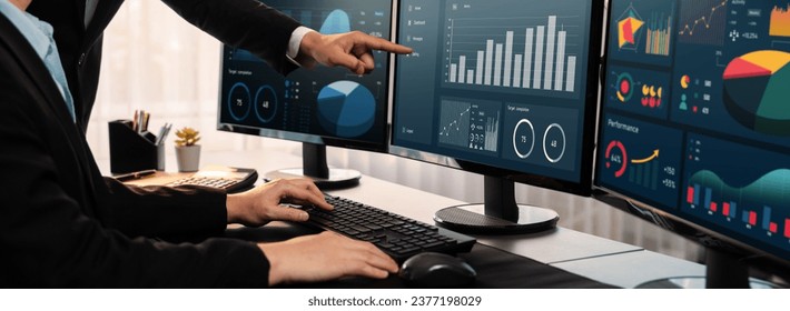 Analyst working on data analysis or BI dashboard on computer monitor. Business team analyzing financial data by Fintech in corporate office for business marketing and strategy planning. Trailblazing - Powered by Shutterstock