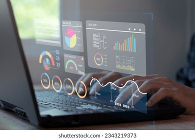 Analyst working on laptop showing business analytics data and data management system with KPIs and metrics connected to financial database.
