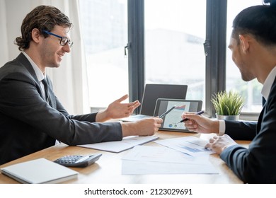 Analysts or financial advisors provide advice on securities analysis and bank treasury. A businessman presents a documented investment plan through graphs and charts. Brainstorm and work together - Shutterstock ID 2123029691