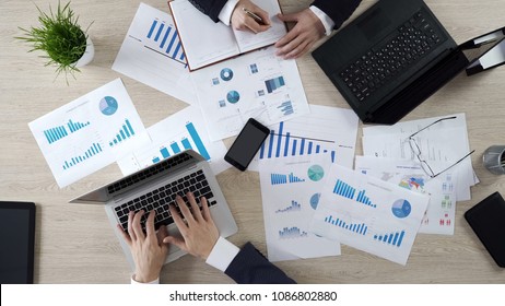 Analysts studying opinion poll statistics, preparing election campaign strategy - Shutterstock ID 1086802880