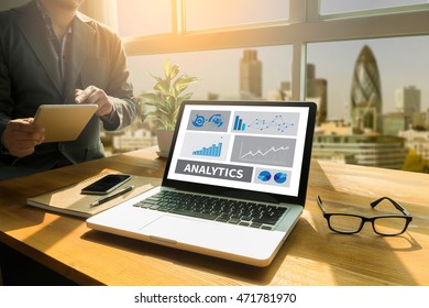 ANALYTICS (Analysis Analytic Marketing  Graph Diagram) Thoughtful male person looking to the digital tablet screen, laptop screen,Silhouette and filter sun