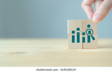 Analytics of HR, People, customer concept. Deeply data driven, advanced analytics for achieve sustainable business success. Wooden cubes with people,buyer, customer analytics icon on smart background. - Shutterstock ID 2145100119