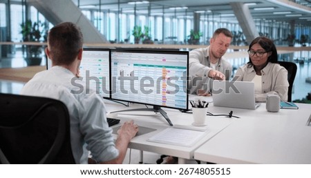 Analyzing Billing Reports With Spreadsheet Software: Diverse Business Team At Work.