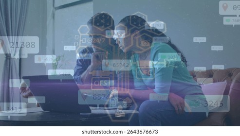 Analyzing couple exploring floating data overlays on laptop in living room, with sofa and plant. Technology, collaboration, digital, analysis, workspace, modern, intelligence