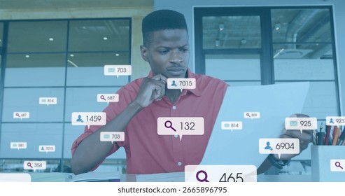 Analyzing data analyst wearing red shirt reviewing on laptop in modern office, with overlay icons. Professional, innovation, productivity, technology, workspace, analytics, contemporary - Powered by Shutterstock - Get 15% off with code: PIKWIZARD15