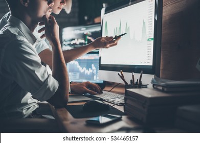 Analyzing data. Close-up of young business team working together in creative office while young woman pointing on the data presented in the chart with pen  - Shutterstock ID 534465157