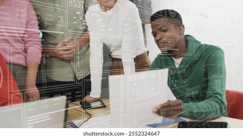 Analyzing data and discussing, diverse team in office with digital interface image. Teamwork, collaboration, diversity, technology, innovation, brainstorming - Powered by Shutterstock