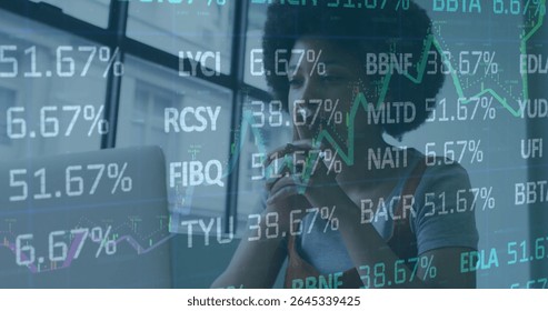 Analyzing financial data overlays on laptop screen at desk in office, woman holding pen to lips. Professional, investment, analytics, modern, corporate, data, workplace