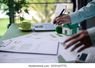 Analyzing green building performance metrics during business meeting. data analysis, green building, business meeting, sustainability, performance metrics, charts, graphs, real estate, eco-friendly.