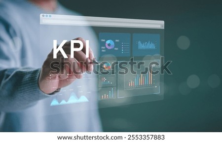 Analyzing Key Performance Indicators. Businessman using virtual screen to analyze key performance indicators KPI with various graphs and charts, showcasing data analysis and performance tracking.