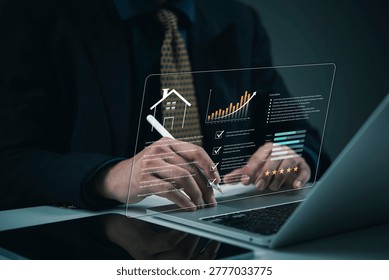 Analyzing real estate market data using glowing hologram interface on laptop businessman professional property investment appraisal smart home valuation PropTech analytics technology solution.