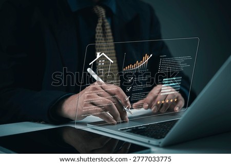 Analyzing real estate market data using glowing hologram interface on laptop businessman professional property investment appraisal smart home valuation PropTech analytics technology solution.