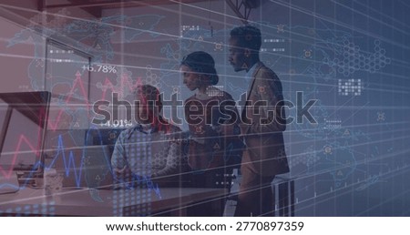 Analyzing team in suits leaning over laptop, monitor at desk with coffee mug, viewing charts. Colleagues, analytics, graphs, worldmap, office, daylight, collaboration
