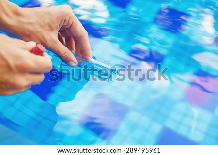 Analyzing of a water from swimming pool, taking water sample to a flask