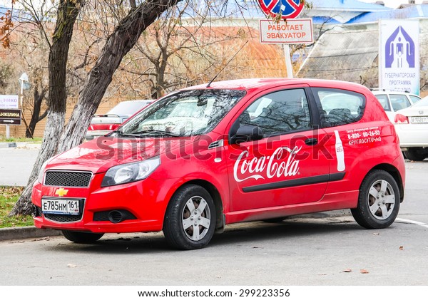 ANAPA, RUSSIA - NOVEMBER 21, 2014: Red\
Coca-Cola car Chevrolet Aveo at the city\
street.
