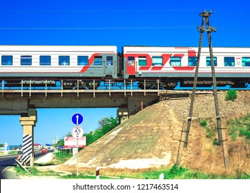 Anapa / Russian Federation - August 15, 2018: Passenger Train Rides Over Bridge Across Highways