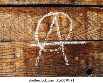 Anarchist Symbol On Wooden Wall Written In Chalk